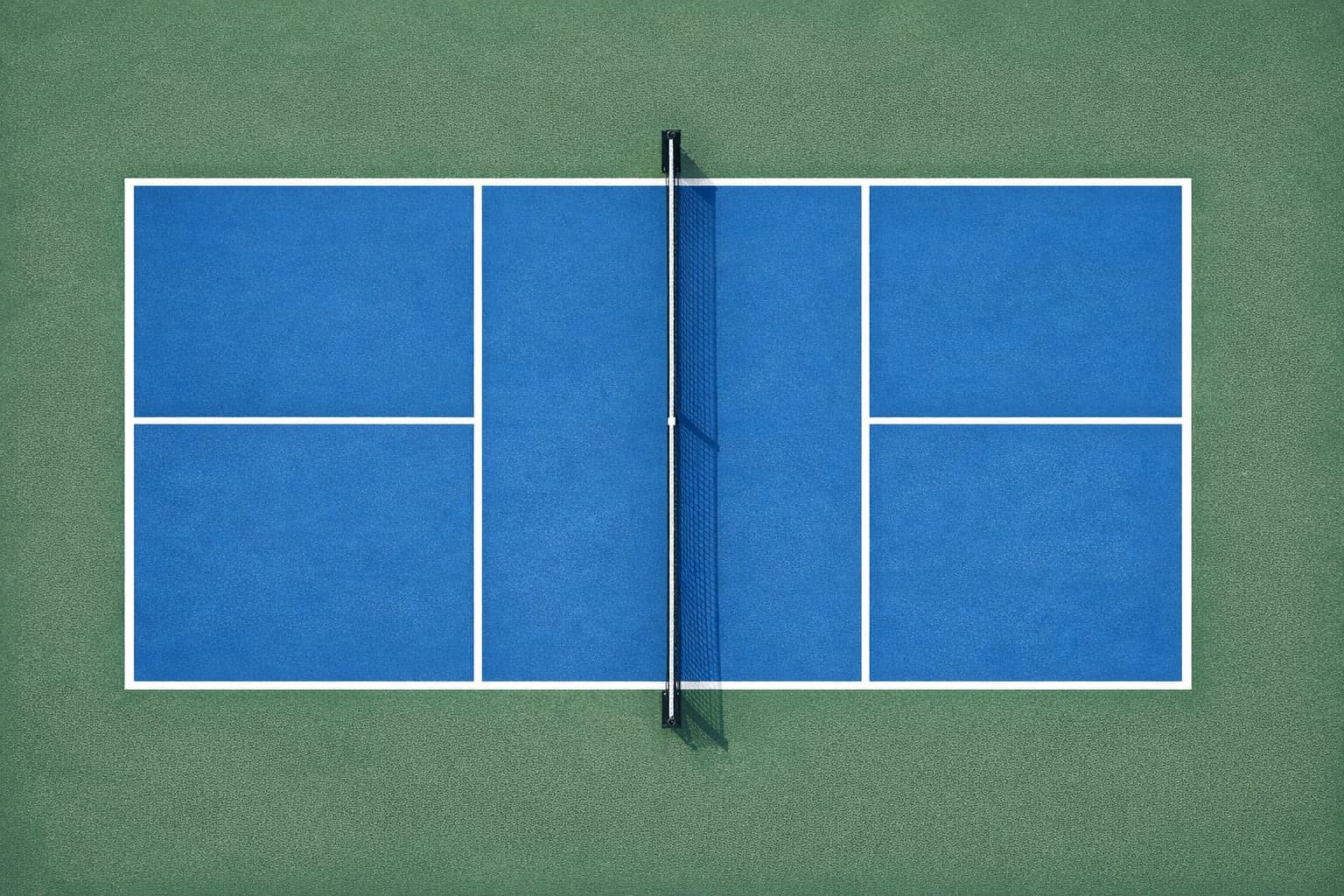 Regulation outdoor concrete pickleball court with official USA Pickleball line markings — 20x44 ft with kitchen zones, centerline, sidelines, and baselines